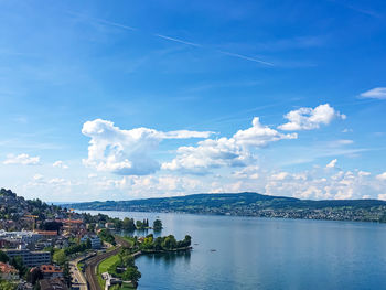 Panoramic view of sea and city buildings against sky