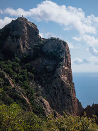 Rock formations in sea against sky