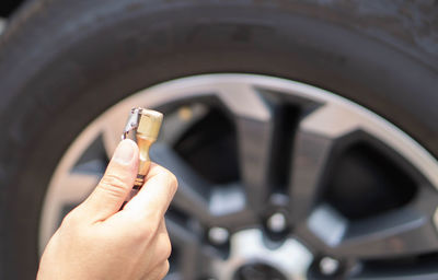 Close-up of person hand holding car