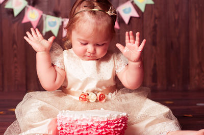 Cute girl playing with cake