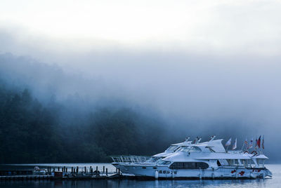 Yachts moored at harbor in lake