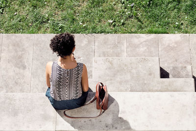 Full length of woman sitting outdoors