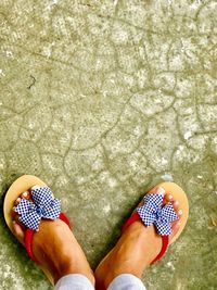 Low section of person wearing shoes standing on ground