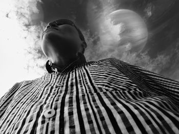 Directly below shot of man standing against sky