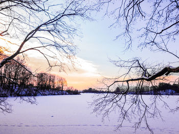 Scenic view of lake against sky during winter