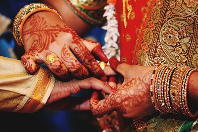 Midsection of bride exchanging ring during wedding ceremony