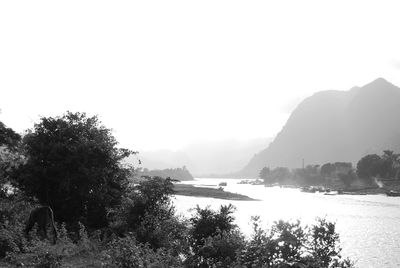 Scenic view of calm river against clear sky