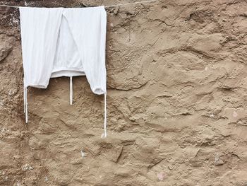 Close-up of clothes drying against wall