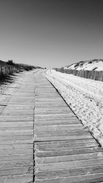 Boardwalk against clear sky