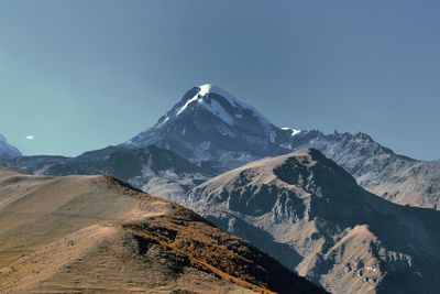 Scenic view of snowcapped mountains against clear sky