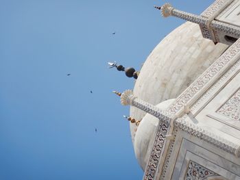 Low angle view of traditional building against blue sky