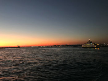 Scenic view of sea against clear sky during sunset