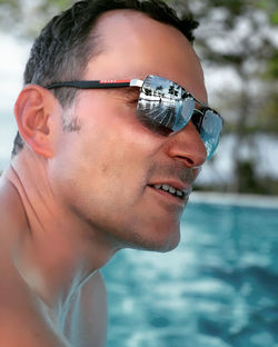 Close-up portrait of young man in swimming pool