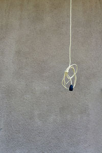 Close-up of electric hanging on wall