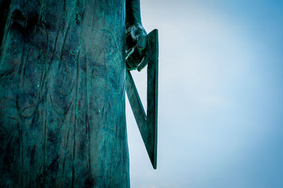 Low angle view of sculpture against blue sky