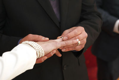 The hands of a bride and a groom