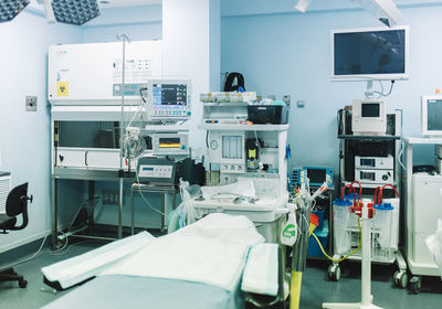 Empty operating room with clean table and modern equipment ready for surgery in hospital