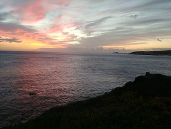 Scenic view of sea against romantic sky at sunset