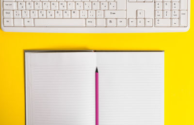 Directly above shot of pencil and book on table