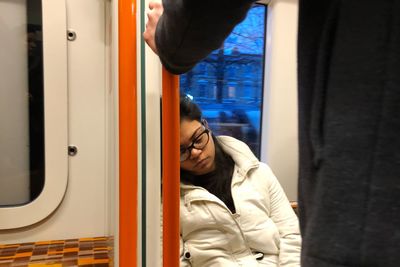 Full length of young woman in train