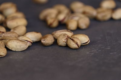 Close-up of pistachios on gray table