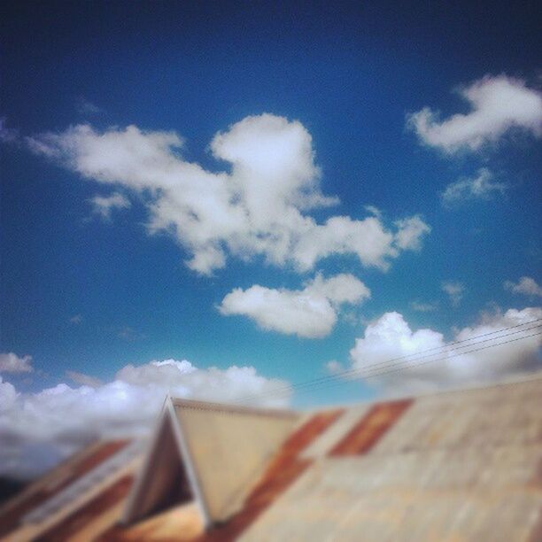 sky, wood - material, cloud - sky, blue, built structure, roof, cloud, day, wooden, architecture, building exterior, no people, outdoors, wood, nature, low angle view, selective focus, cloudy, sunlight, house