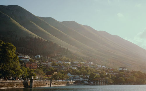 Scenic view of lake by mountain against sky