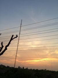 Low angle view of electricity pylon against sky