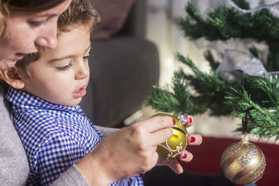 Midsection of boy holding christmas tree