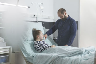 Side view of doctor examining patient at clinic