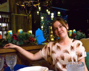 Portrait of young woman sitting at restaurant
