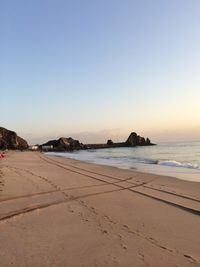 Scenic view of beach against clear sky