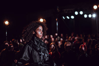 Young woman looking at music concert