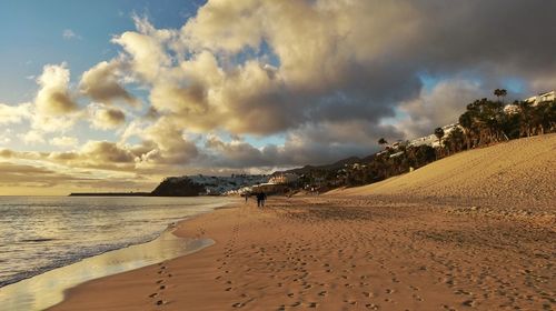 Panoramic view of beach against sky during sunset