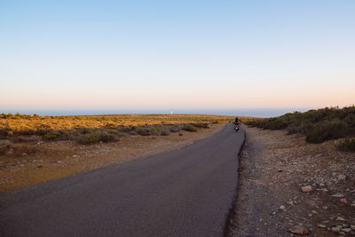 Road amidst landscape against clear sky