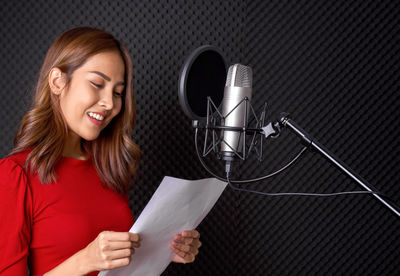 Portrait of a smiling young woman using mobile phone