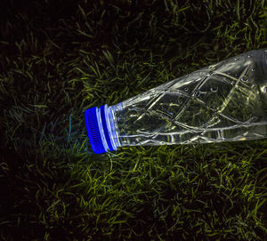 Close-up of umbrella on grass against black background