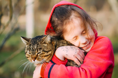 Close-up of girl and cat
