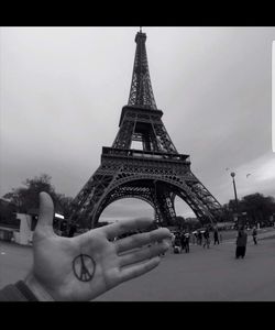 Low angle view of hand against buildings