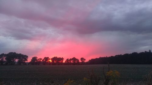 Scenic view of field against sky during sunset