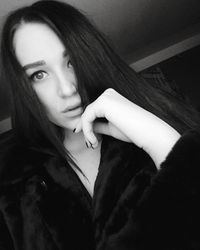 Close-up portrait of young woman at home