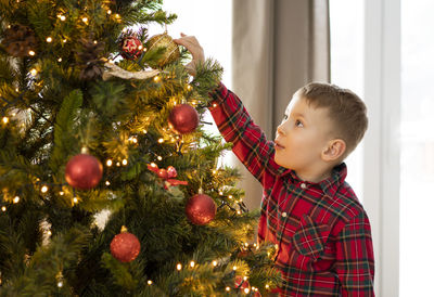 Portrait of girl decorating christmas tree