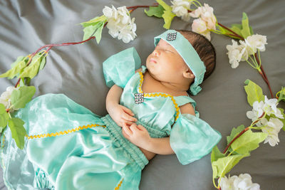 High angle view of cute baby girl sleeping on bed