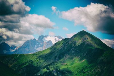 Scenic view of mountains against cloudy sky