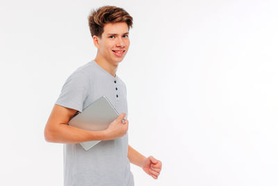Portrait of smiling young man against white background