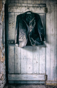 Old coat hanging on door