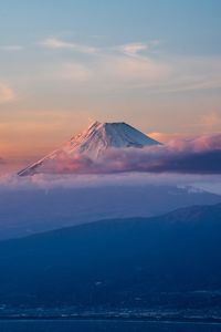 Scenic view of snowcapped mountain against cloudy sky