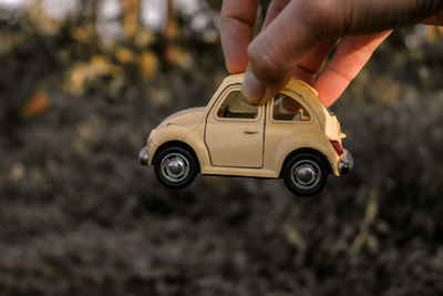 Cropped image of hand holding toy car
