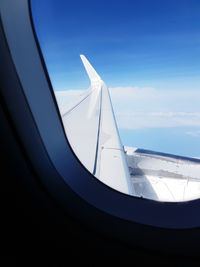 Low angle view of airplane wing against sky