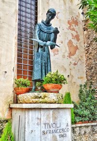 Statue against brick wall